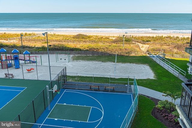 exterior space featuring a beach view, a water view, and a playground