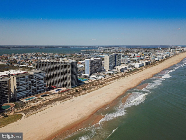 birds eye view of property with a beach view and a water view