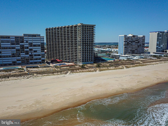 birds eye view of property with a beach view and a water view