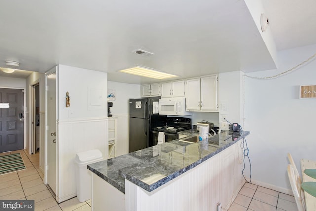 kitchen with black appliances, dark stone countertops, kitchen peninsula, and light tile patterned flooring