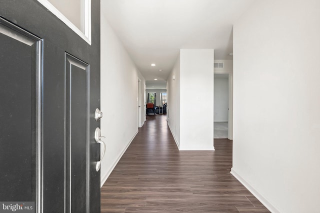 hallway with dark hardwood / wood-style floors