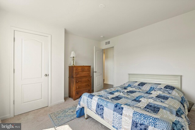 bedroom with light colored carpet