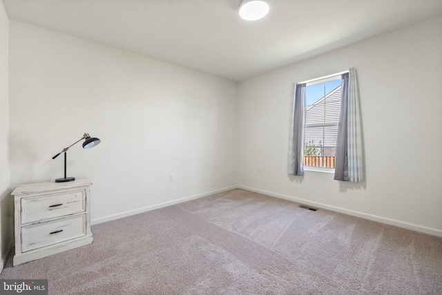 unfurnished bedroom featuring carpet floors, visible vents, and baseboards