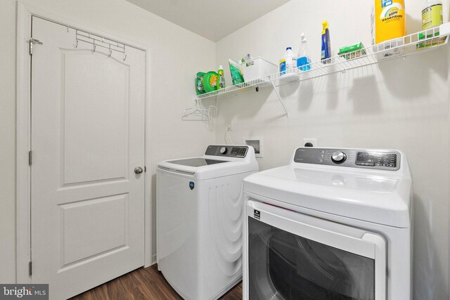 washroom featuring washer and dryer and dark hardwood / wood-style floors