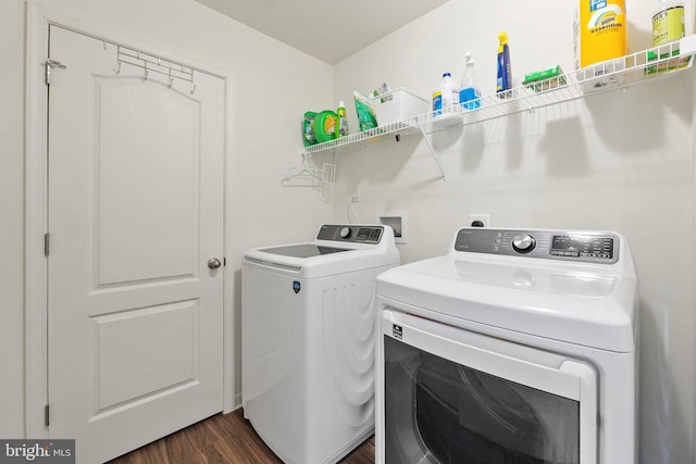 laundry area featuring dark wood-style floors, laundry area, and washing machine and clothes dryer