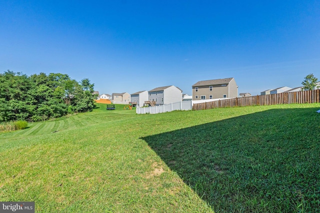 view of yard featuring a residential view and fence