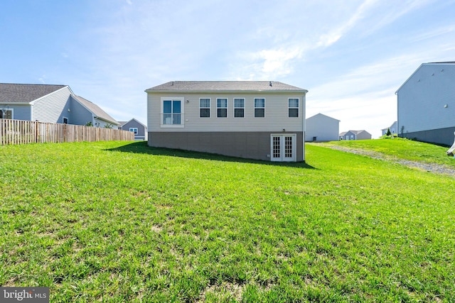 back of house featuring a yard, french doors, and fence