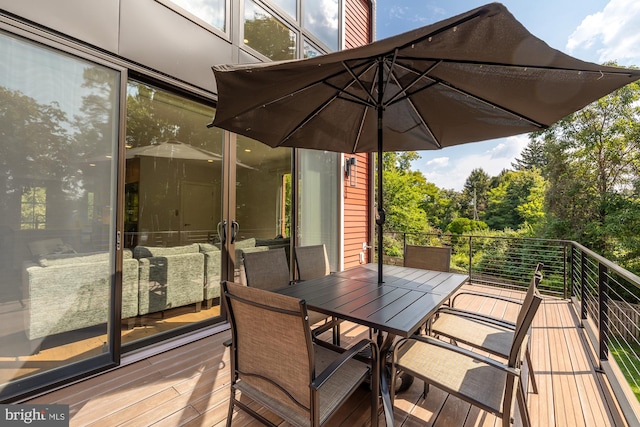 wooden terrace with outdoor dining area