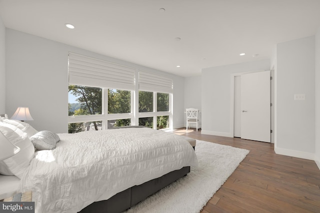 bedroom with recessed lighting, baseboards, and wood finished floors