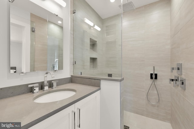 full bathroom featuring a stall shower and vanity