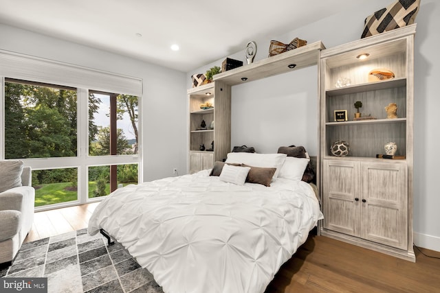 bedroom with dark wood finished floors and recessed lighting