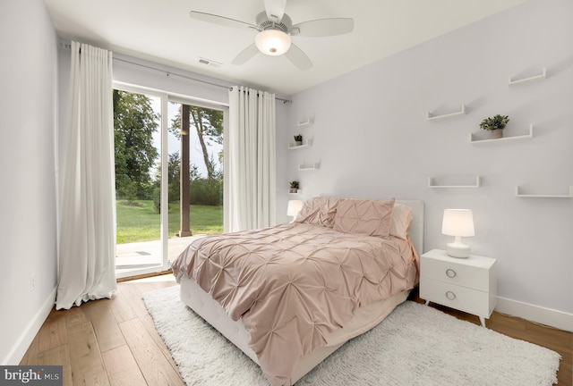 bedroom featuring access to exterior, ceiling fan, and hardwood / wood-style flooring