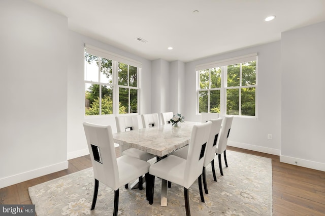 dining area featuring recessed lighting, baseboards, and wood-type flooring