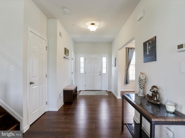 entryway featuring dark wood finished floors, visible vents, and baseboards