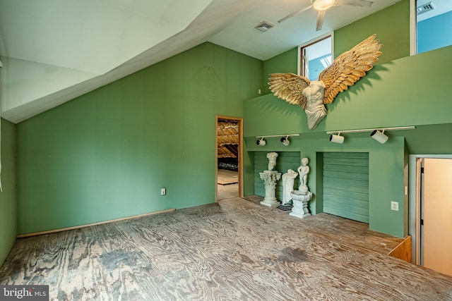 unfurnished living room featuring ceiling fan and lofted ceiling