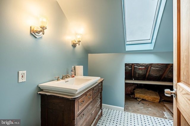 bathroom with lofted ceiling and vanity