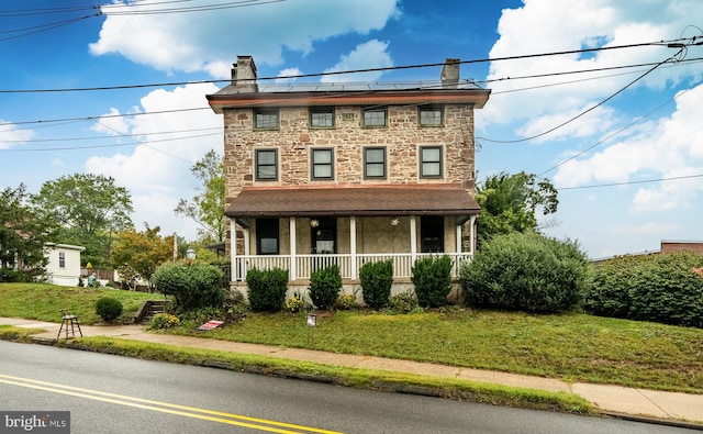 view of front of house featuring a front yard and covered porch