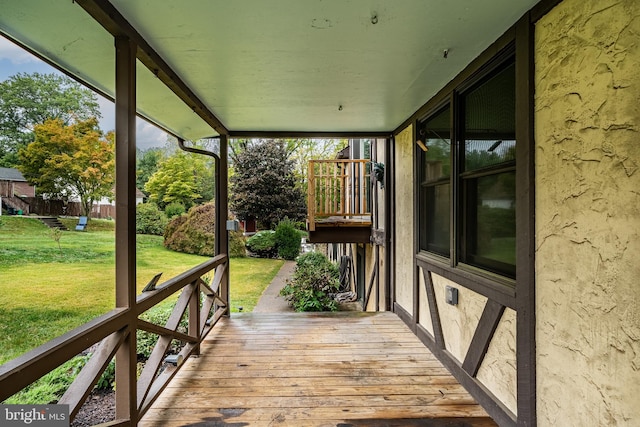 wooden terrace with a yard