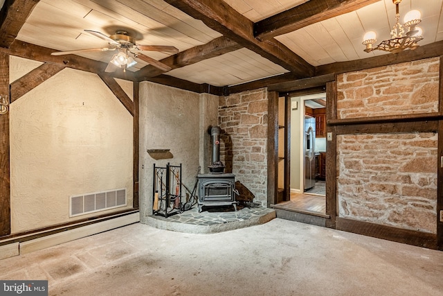 unfurnished living room featuring ceiling fan with notable chandelier, a wood stove, beamed ceiling, and wood ceiling