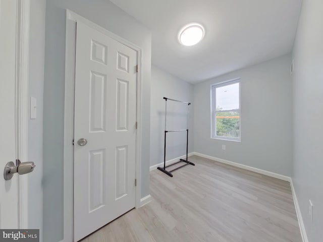 laundry room with light hardwood / wood-style floors