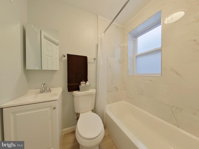 full bathroom with vanity, toilet, shower / bath combo with shower curtain, and ornamental molding