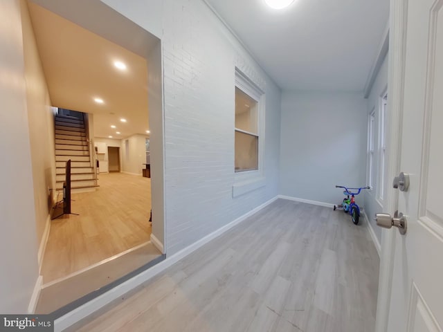 hall with hardwood / wood-style flooring