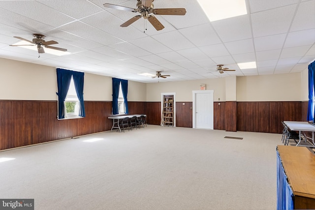 miscellaneous room with carpet flooring, ceiling fan, and a drop ceiling