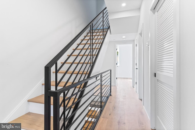 stairs featuring hardwood / wood-style floors