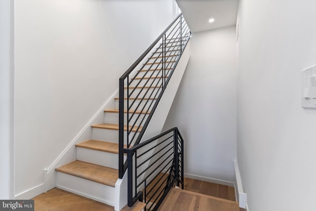 staircase with wood-type flooring