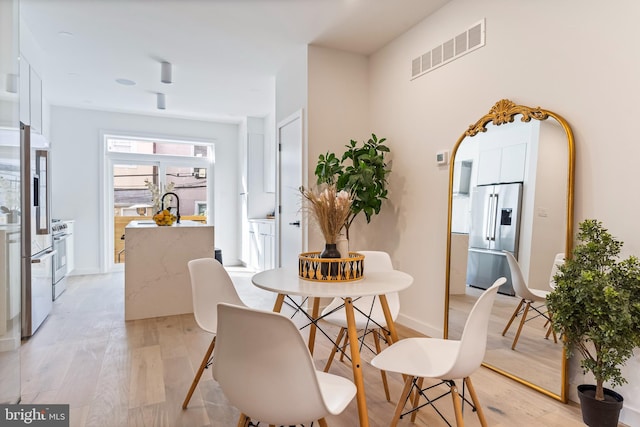 dining space featuring light wood-type flooring