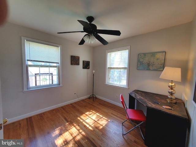 office area featuring hardwood / wood-style floors, a healthy amount of sunlight, and ceiling fan