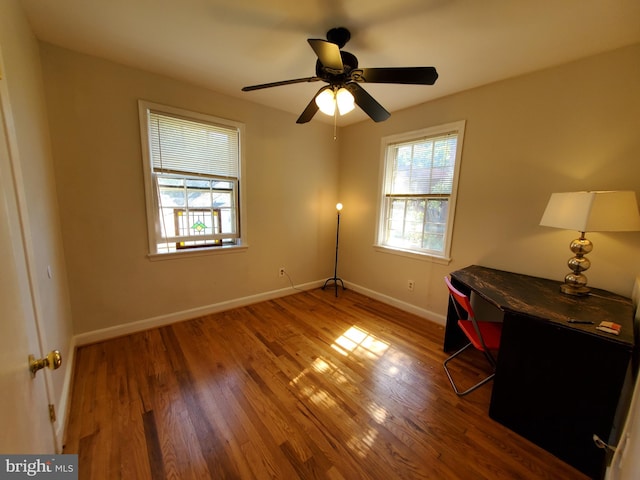 spare room featuring wood-type flooring and ceiling fan