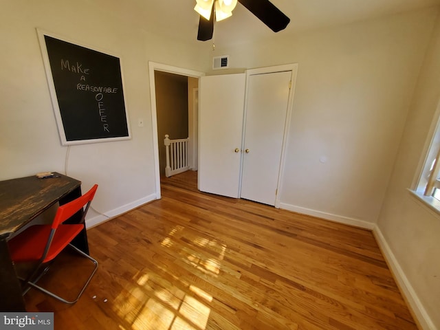 office area with wood-type flooring and ceiling fan