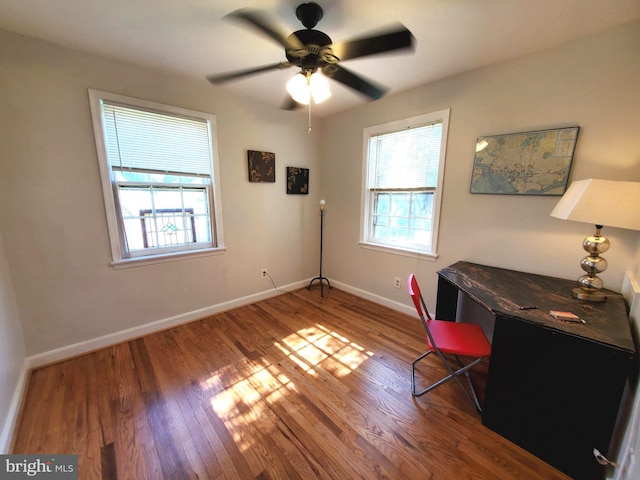 office featuring wood finished floors, baseboards, and ceiling fan