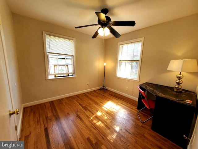 interior space with wood finished floors, baseboards, and ceiling fan
