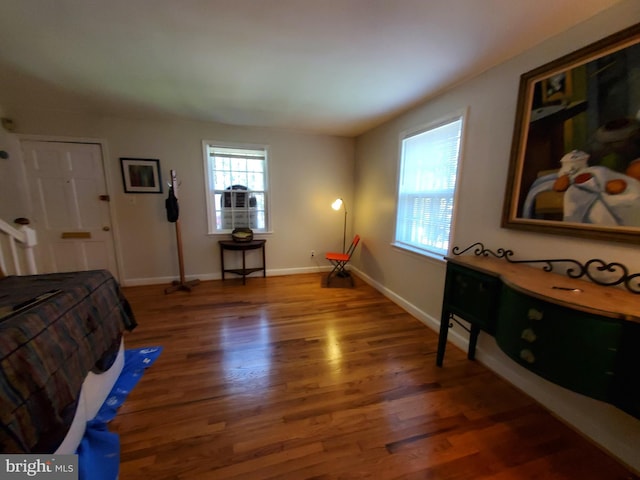 bedroom with dark hardwood / wood-style floors