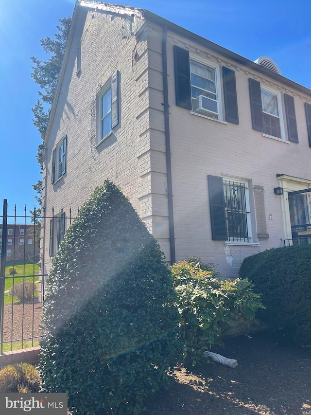 view of side of home featuring brick siding