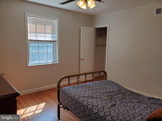 bedroom with light hardwood / wood-style floors and ceiling fan