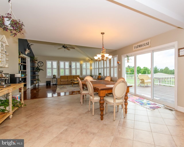 dining space featuring ceiling fan with notable chandelier and light tile patterned flooring