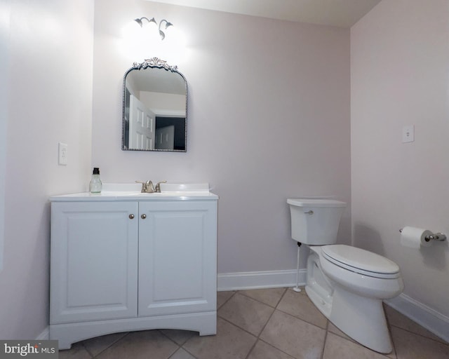 bathroom featuring vanity, toilet, and tile patterned flooring