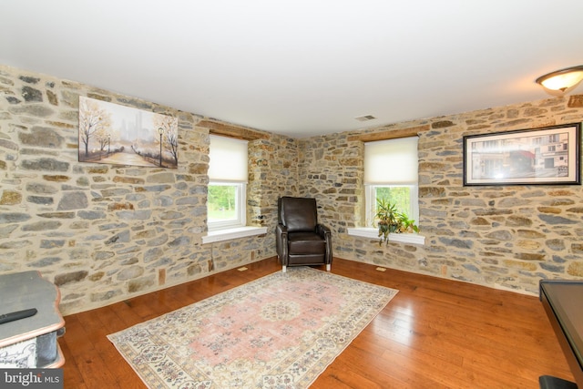 sitting room with hardwood / wood-style flooring