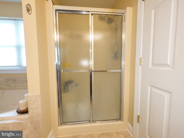 bathroom with tile patterned flooring and plus walk in shower