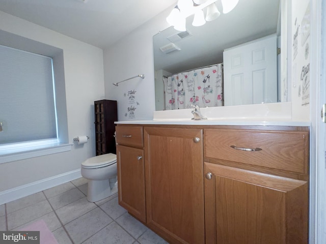 bathroom with tile patterned flooring, vanity, and toilet