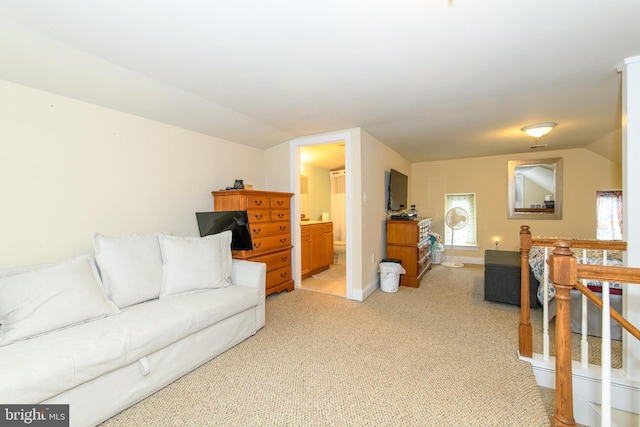 carpeted living room featuring lofted ceiling