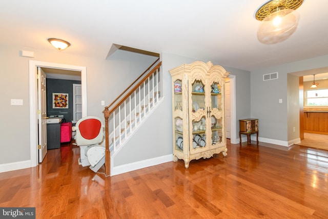 stairway with hardwood / wood-style flooring