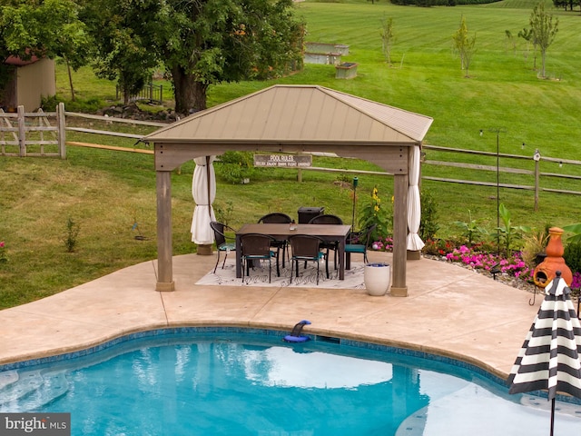 view of swimming pool featuring a yard, a gazebo, and a patio