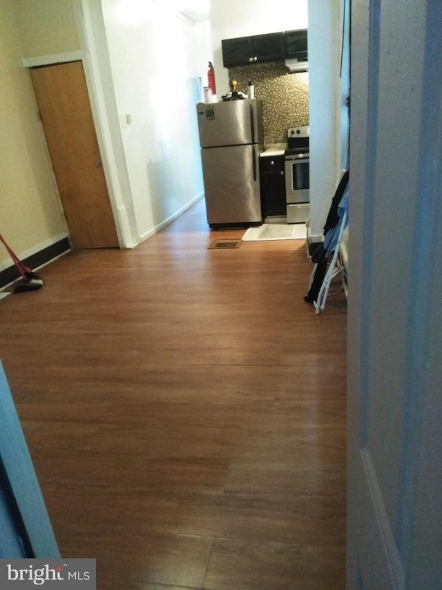 hallway with dark hardwood / wood-style flooring