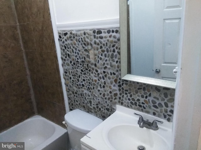 bathroom with decorative backsplash, vanity, and toilet