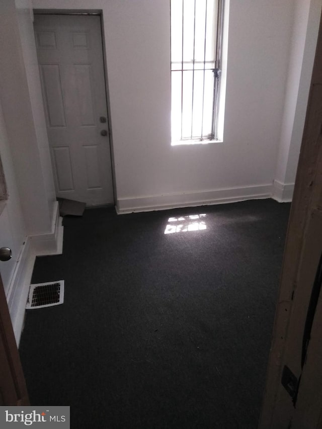 empty room with dark carpet