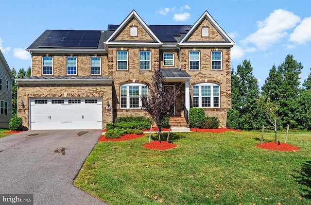 view of front facade featuring a garage, a front lawn, and solar panels